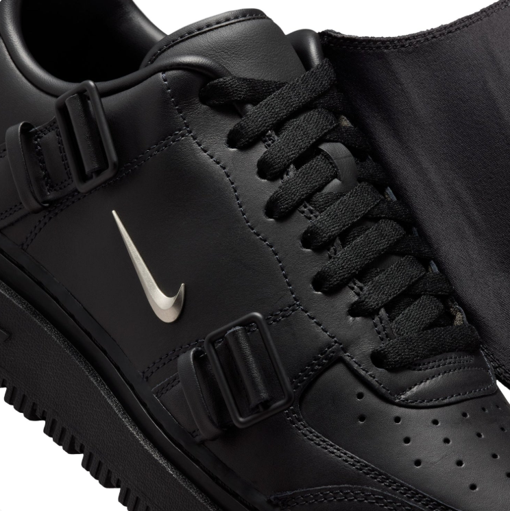 Nike Black Low-Top Sneakers with Buckled Shroud & Silver Swoosh